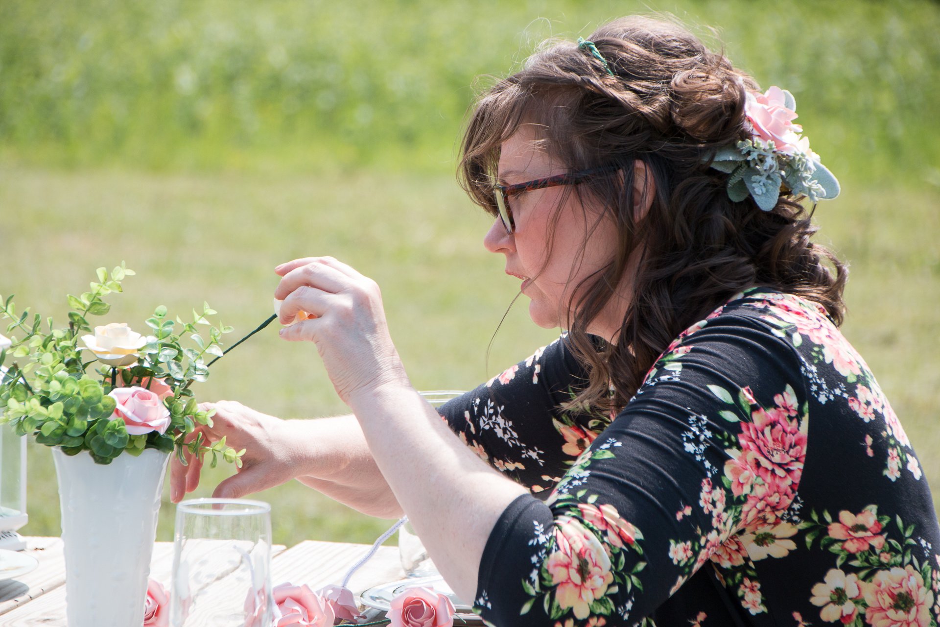 creating paper flower centerpieces outdoor event set-up