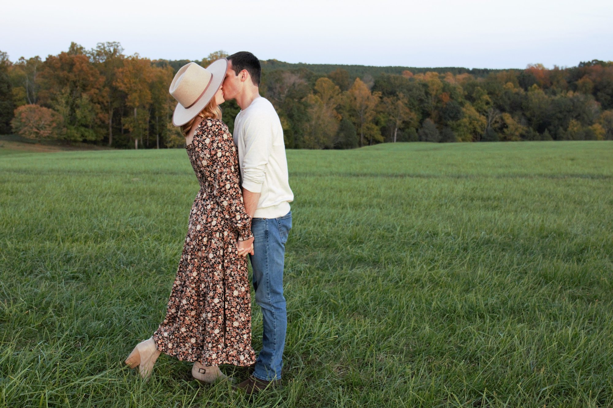 Couples picnic dancing field