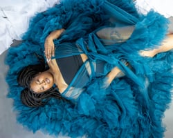 confident woman in a boudoir session with a goddess robe