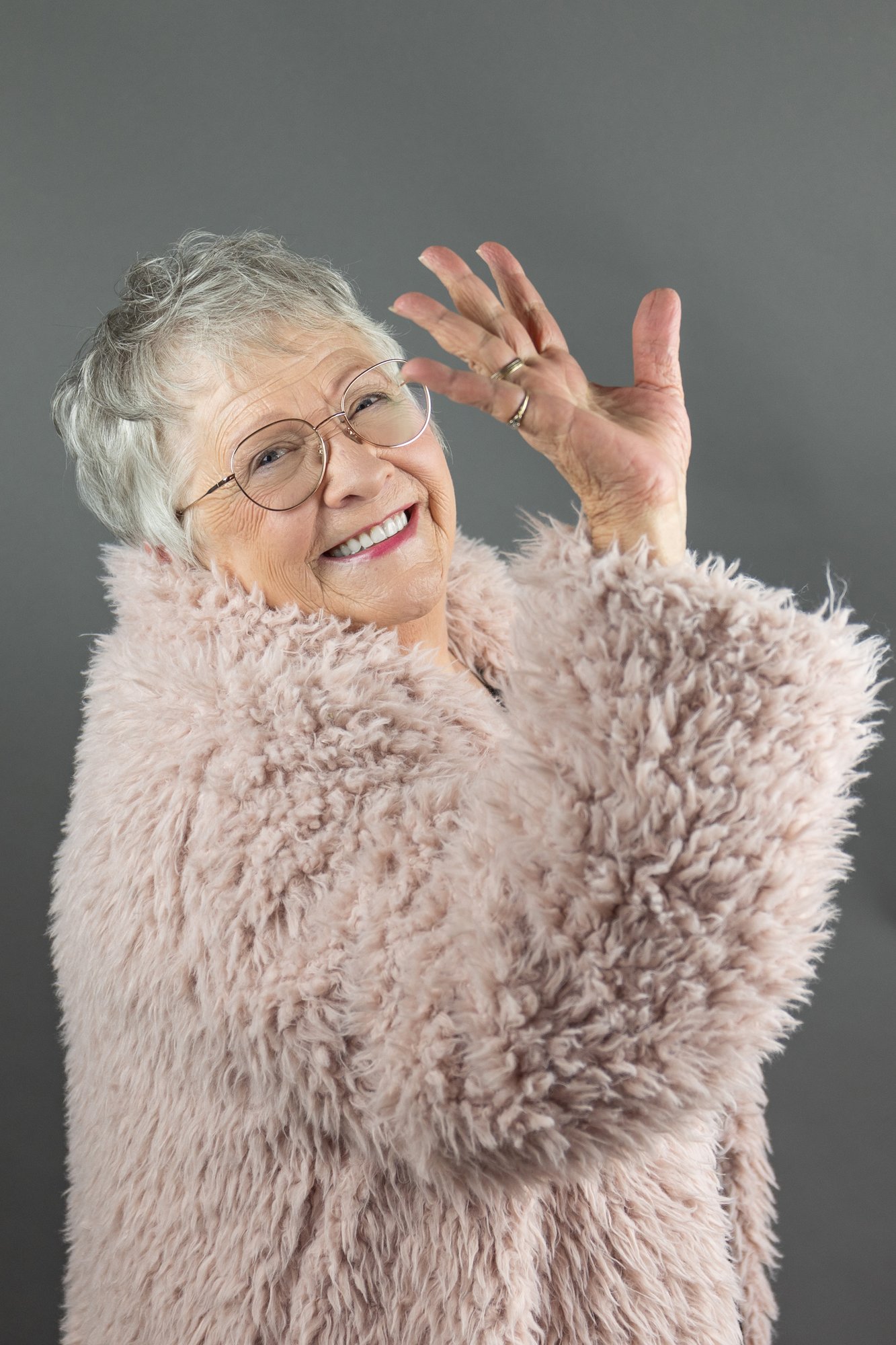 over 50 woman smiling waving