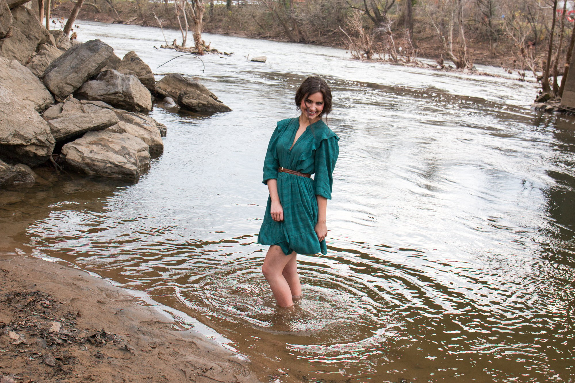 senior girl dancing at the river's edge