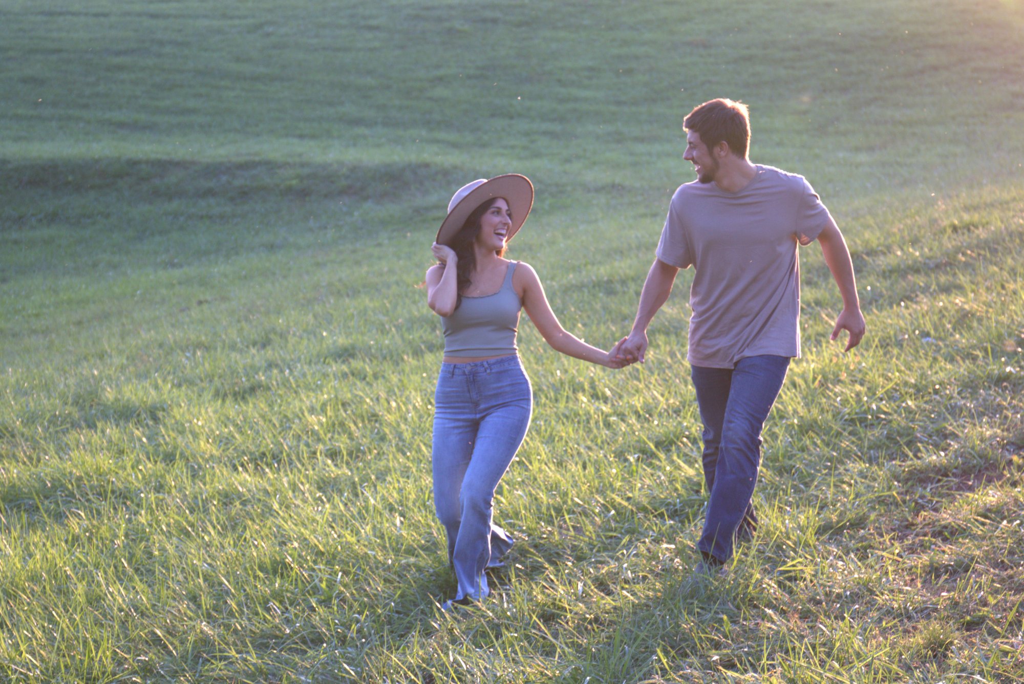 couple running in field couple running in field