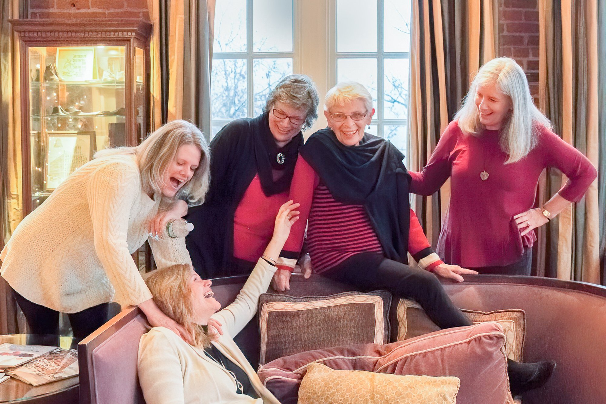 fun mother daughters climbing couch