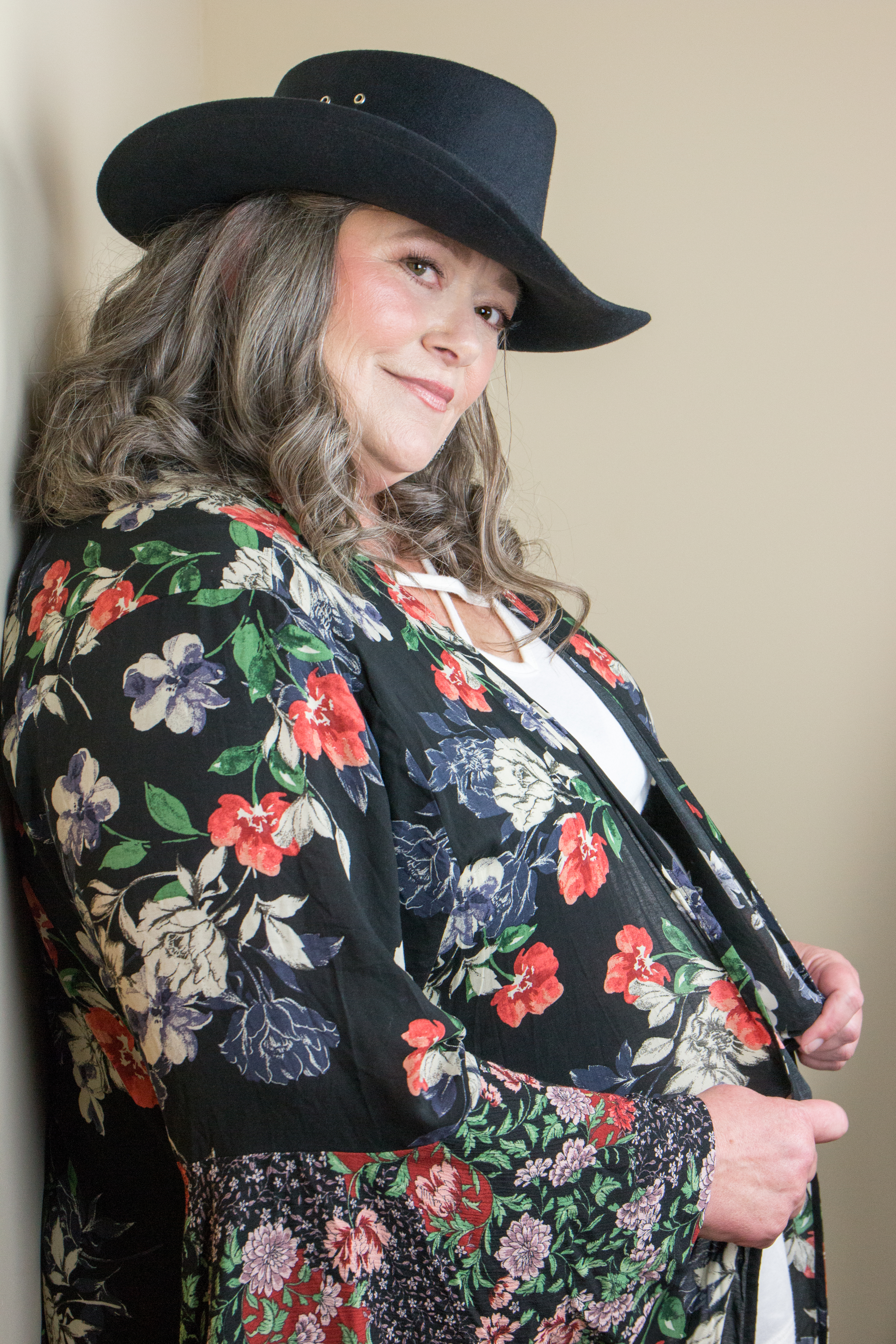 confident woman over 50 in her favorite outfit and hat